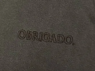 OBRIGADO. embroidered tone on tone on a faded black tee
