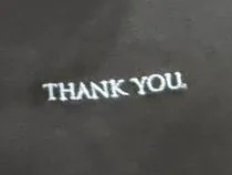 THANK YOU. embroidered in light blue on a washed black tee